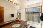 A full bathroom with a tub/shower combo serves the guest bedrooms